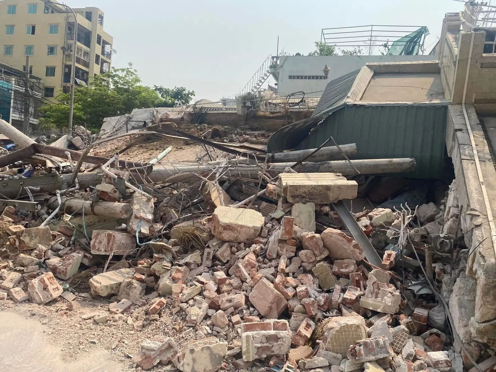 A street of collapsed brick and concrete rubble after the earthquake in Mandalay